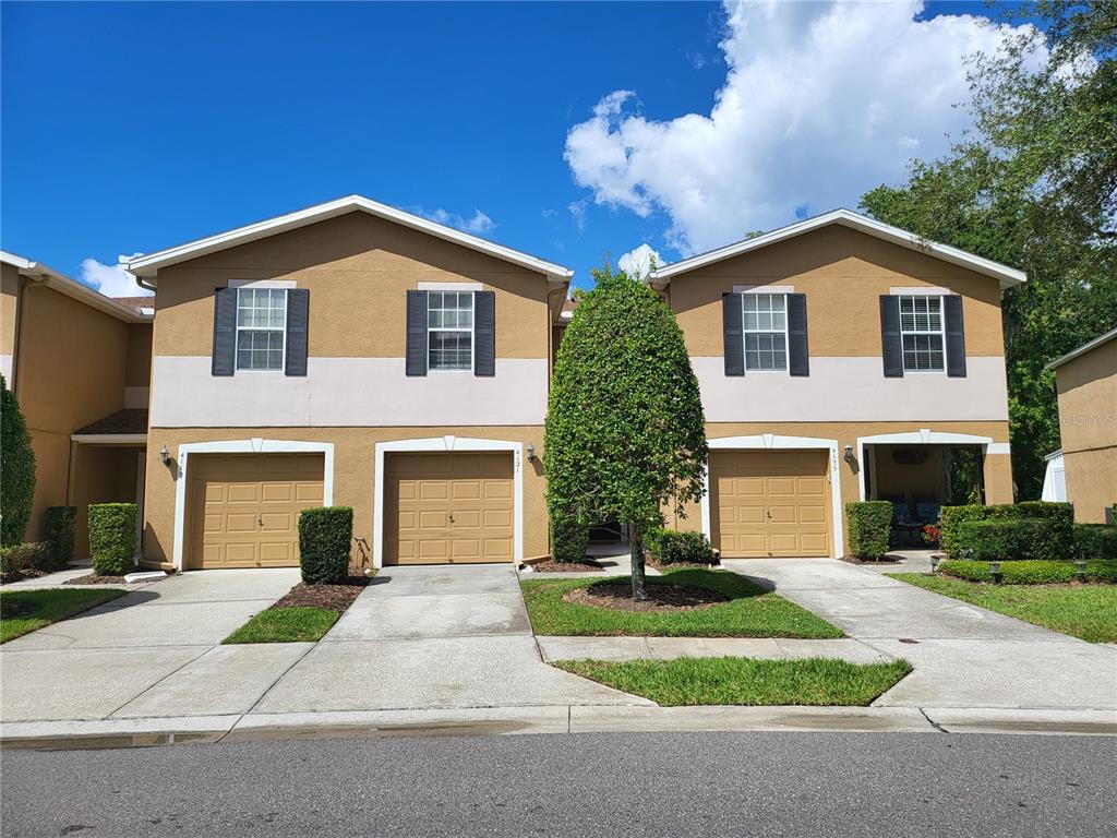 a front view of a house with a yard and garage