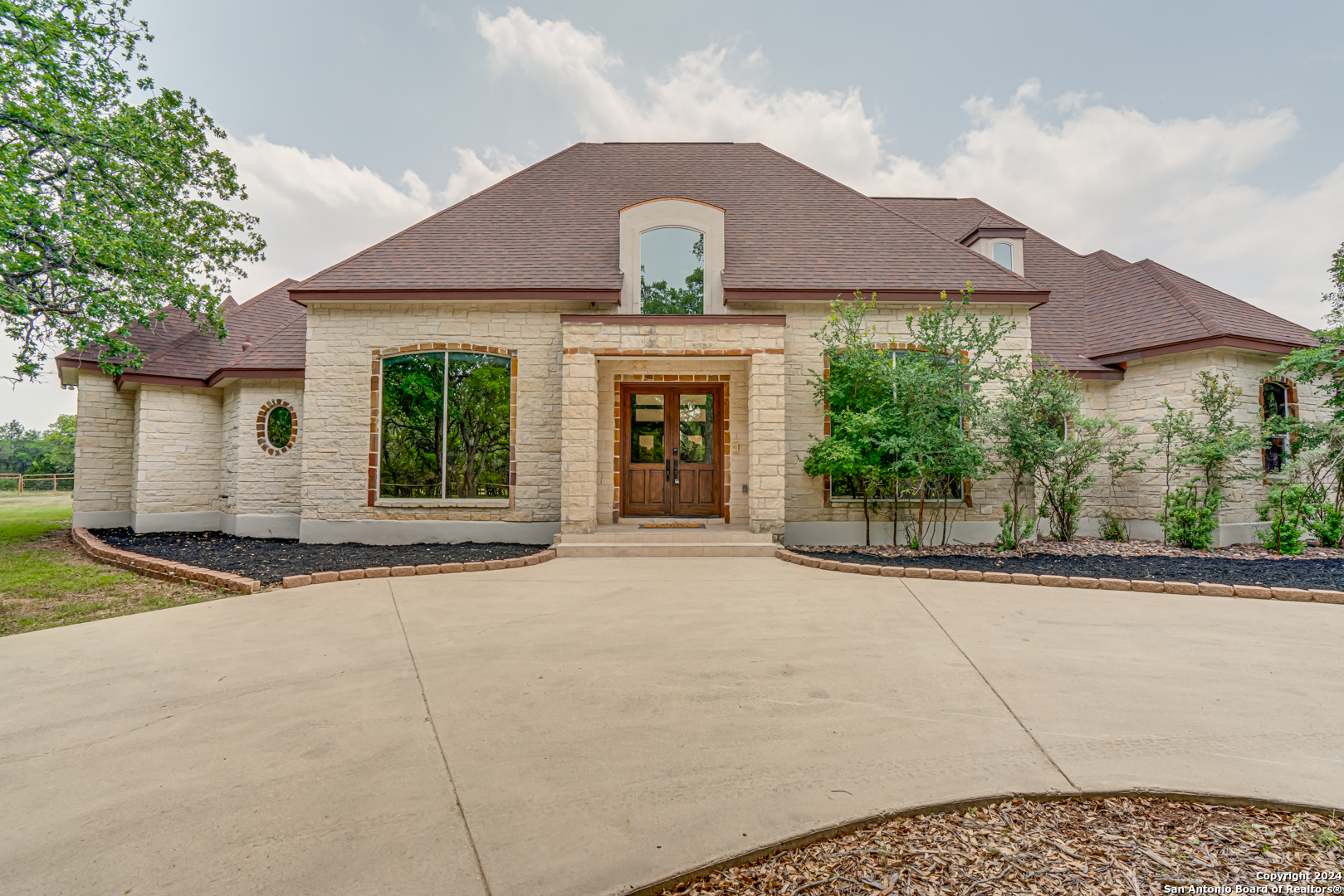 a front view of a house with garden