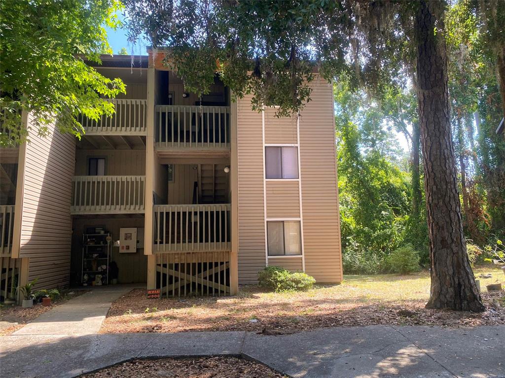 a view of a house with a tree in the background