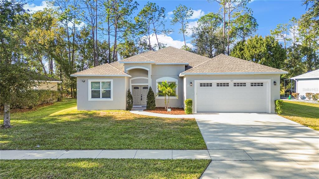 a front view of a house with a yard and garage