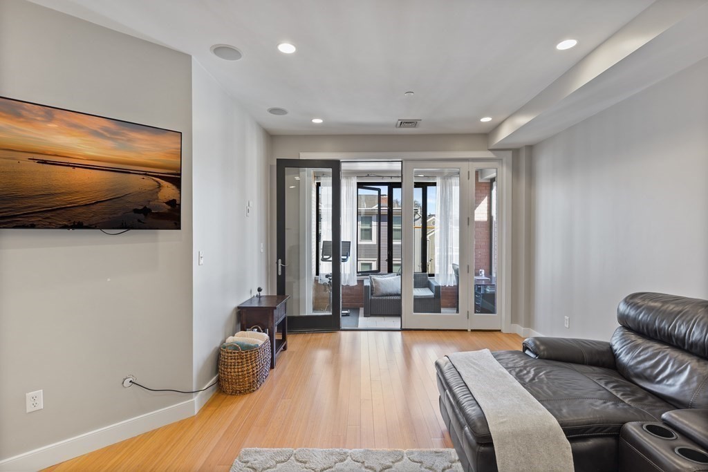 a spacious bedroom with a bed and glass door