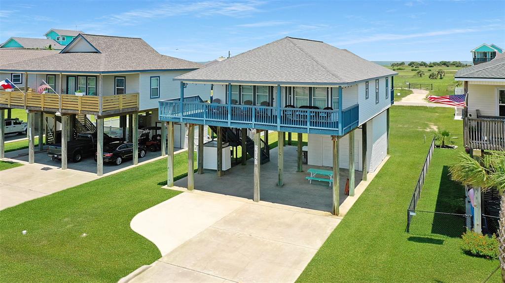 a view of a house with pool and a yard