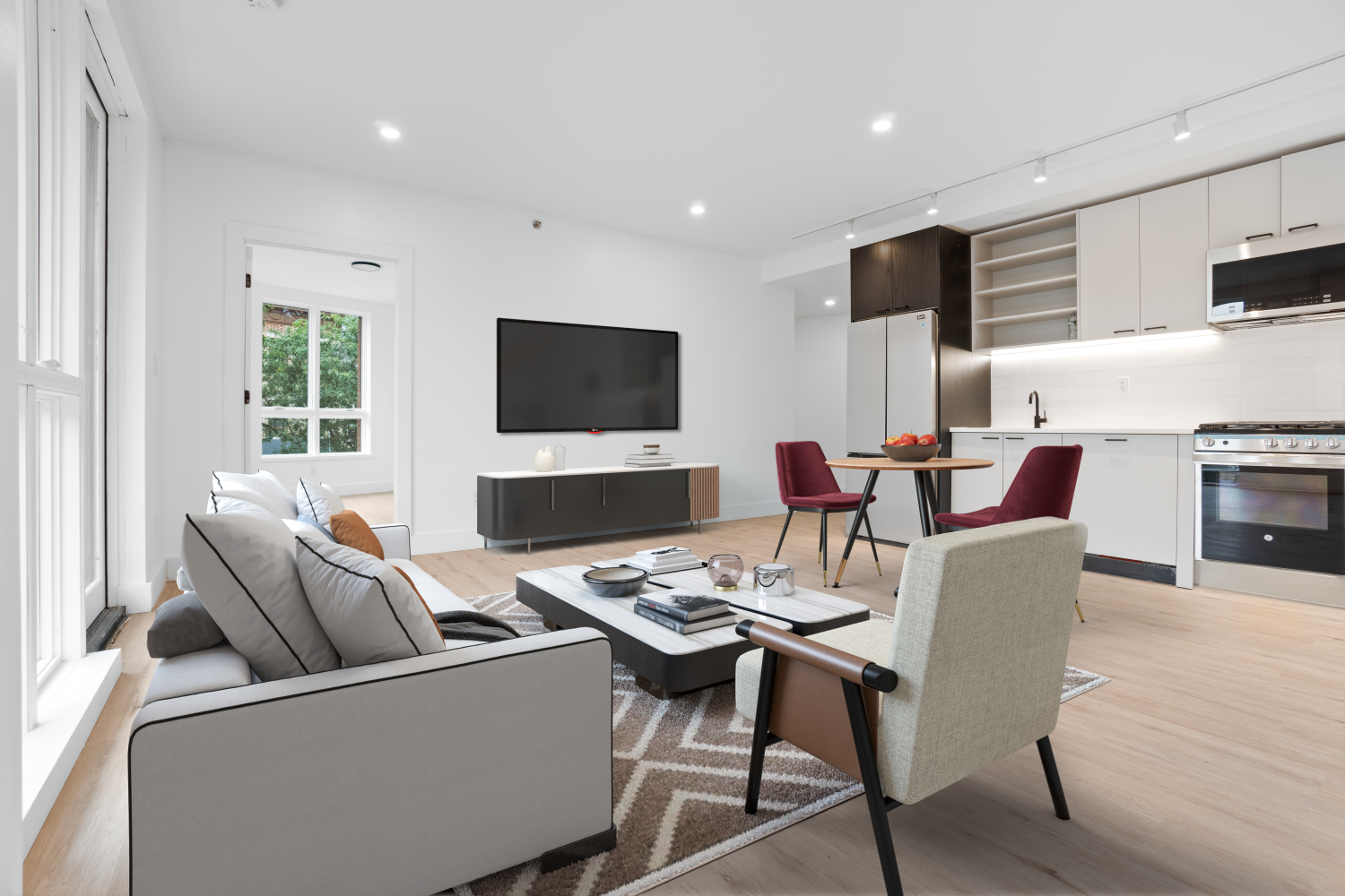 a living room with furniture a flat screen tv and a fireplace