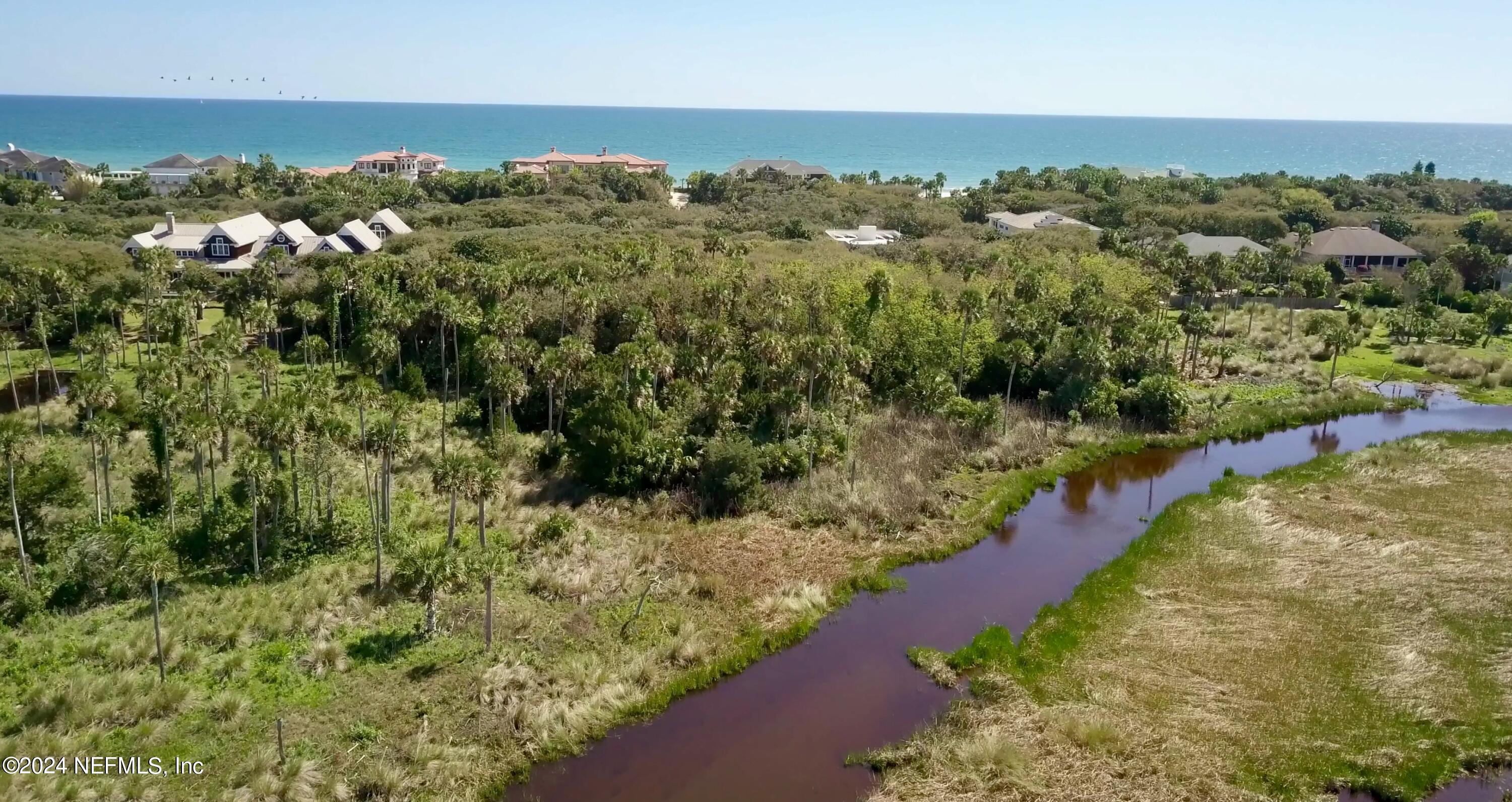 an aerial view of a houses with a yard