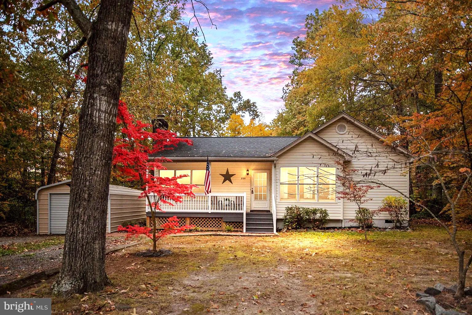 a view of a house with a tree and a yard