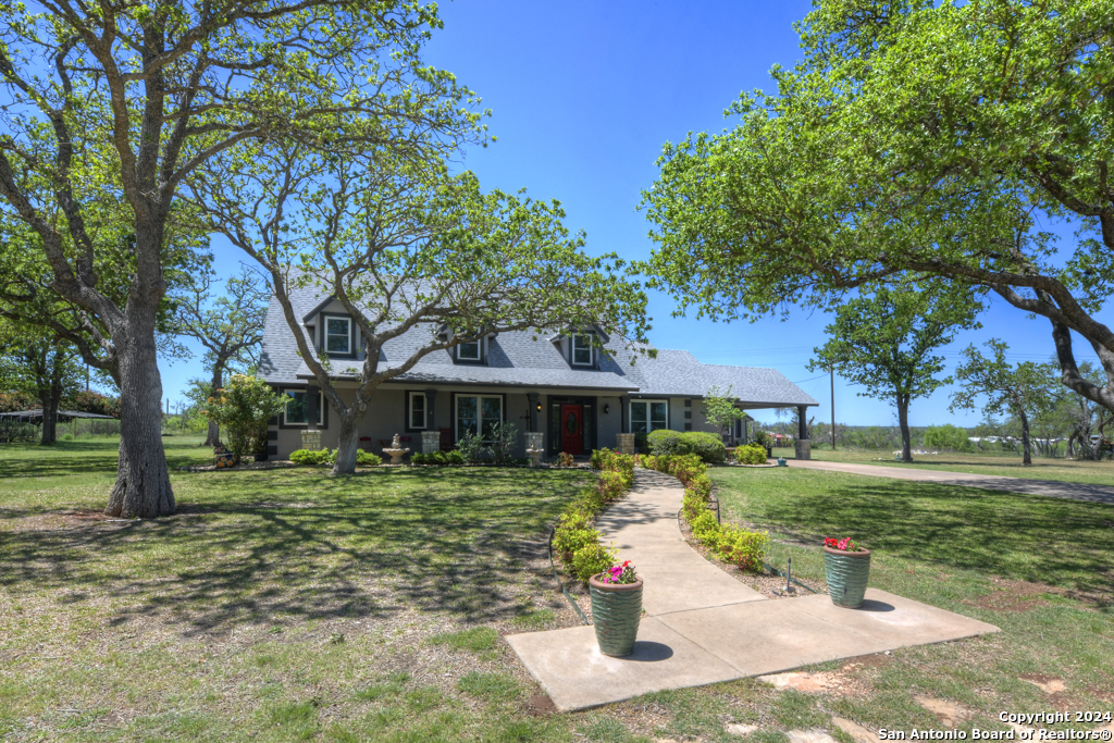 a front view of a house with a yard garage and outdoor seating