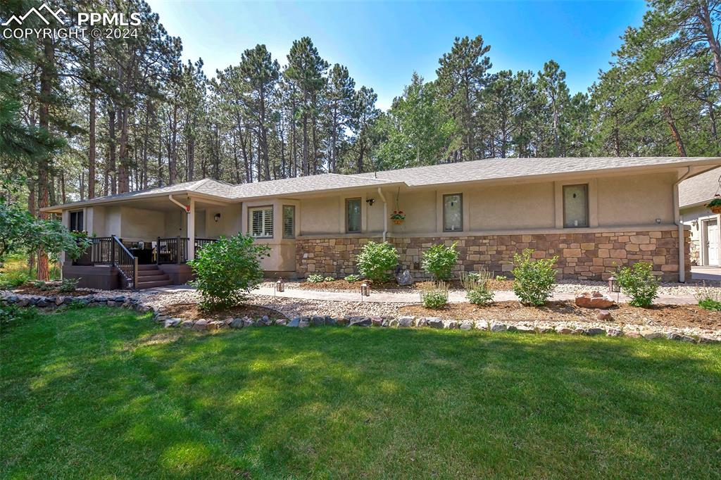 a view of a house with a backyard and a patio