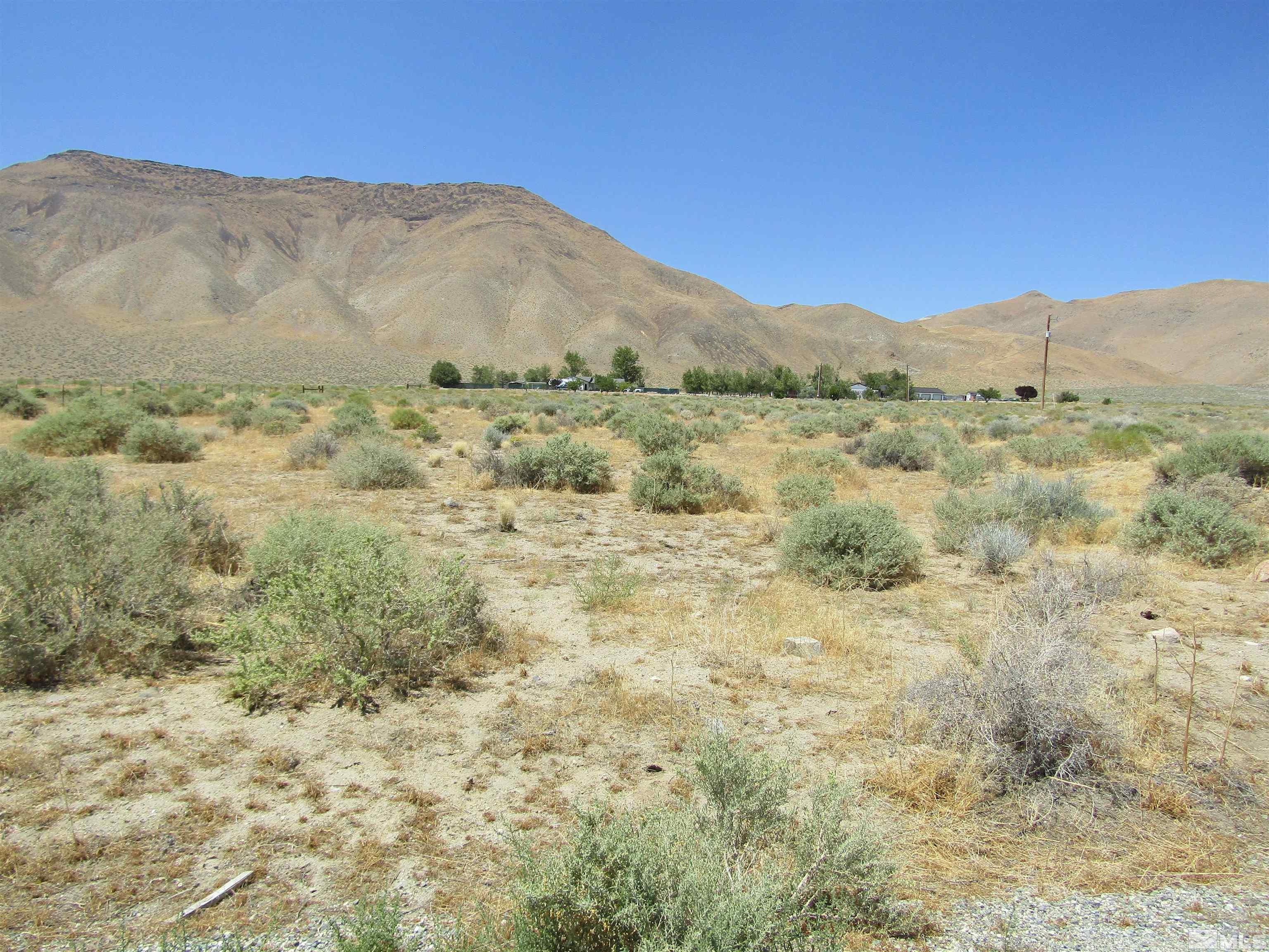 a view of a large mountain with mountains in the background