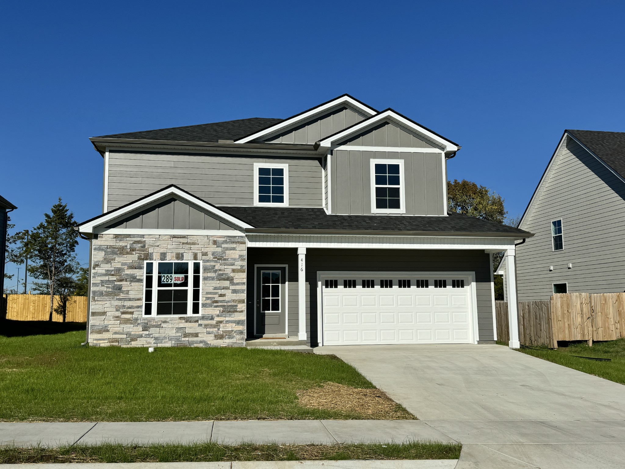 a view of a house with a yard and garage