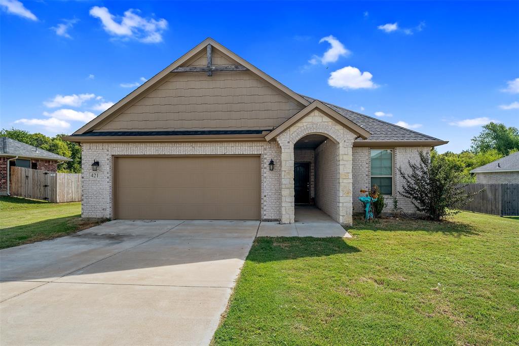 a front view of a house with a yard and garage