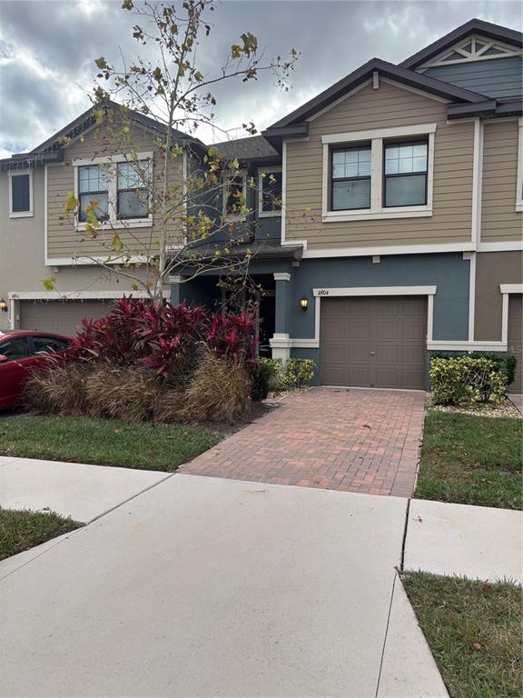 a front view of a house with a yard and garage