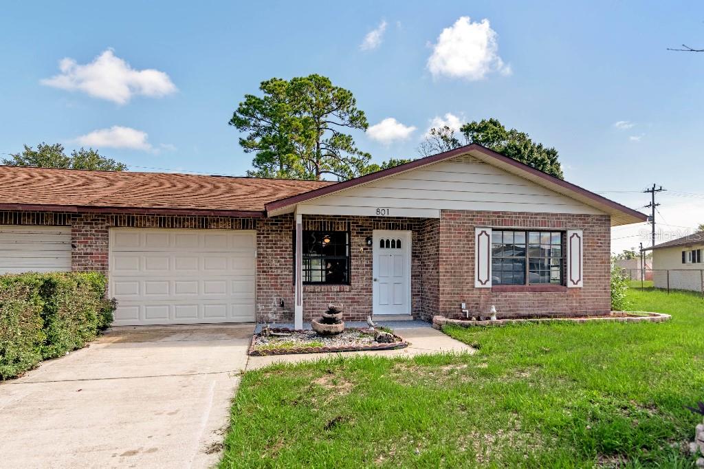 a front view of a house with a yard and porch