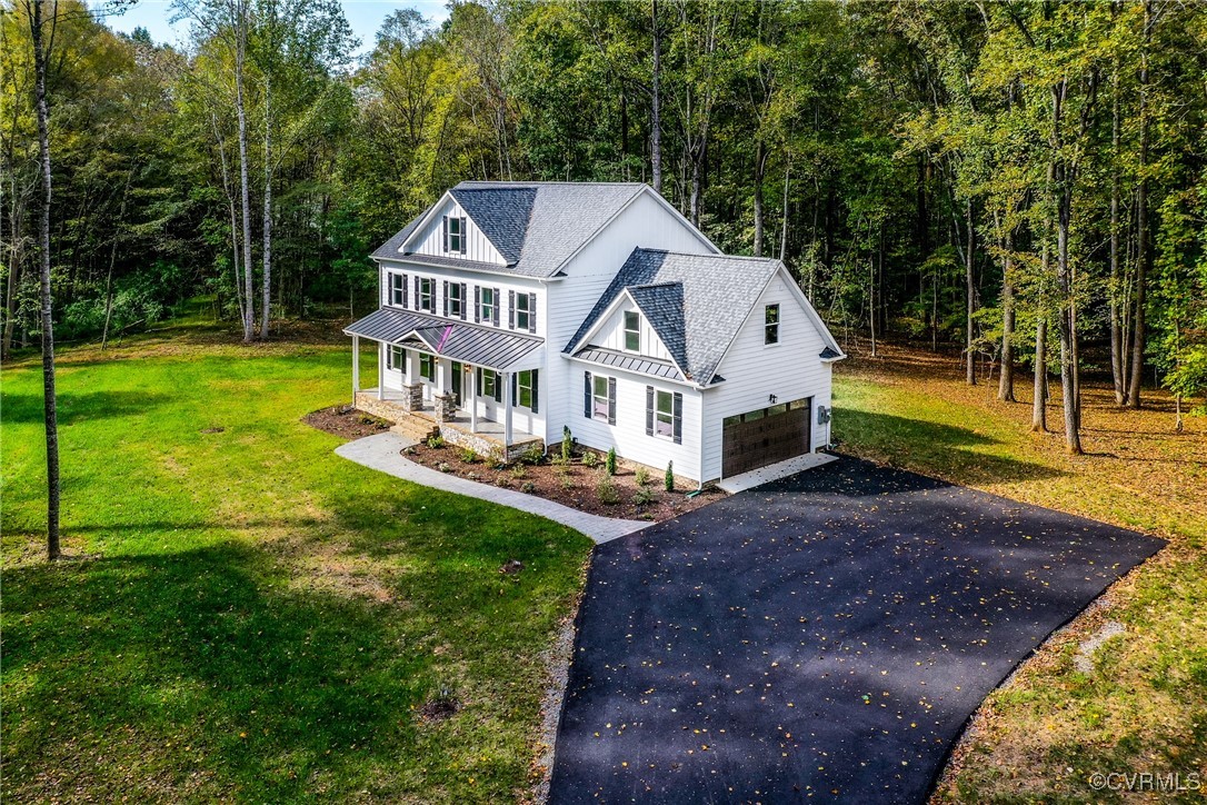 a aerial view of a house with a yard table and chairs