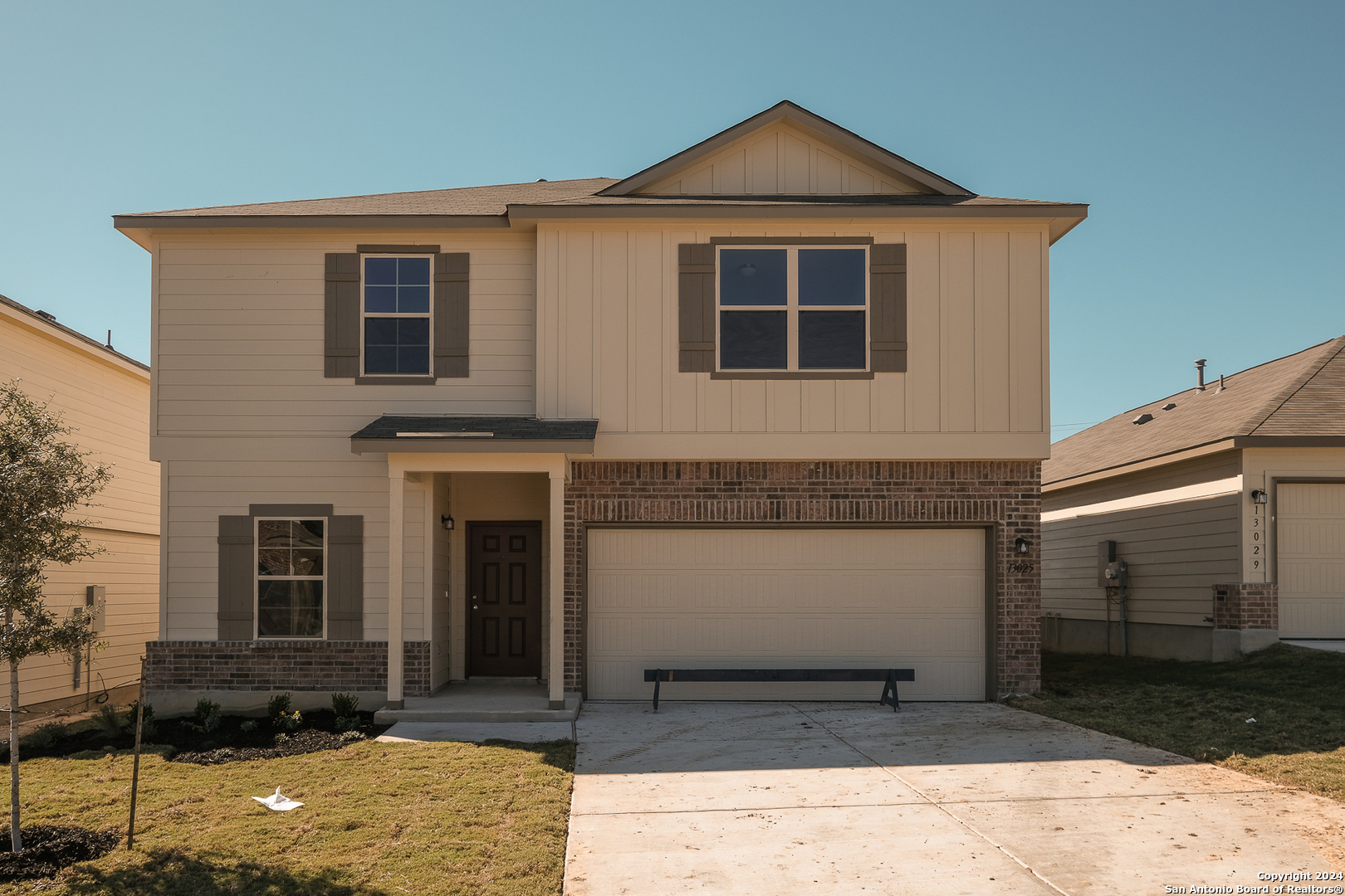 a front view of a house with a yard and garage