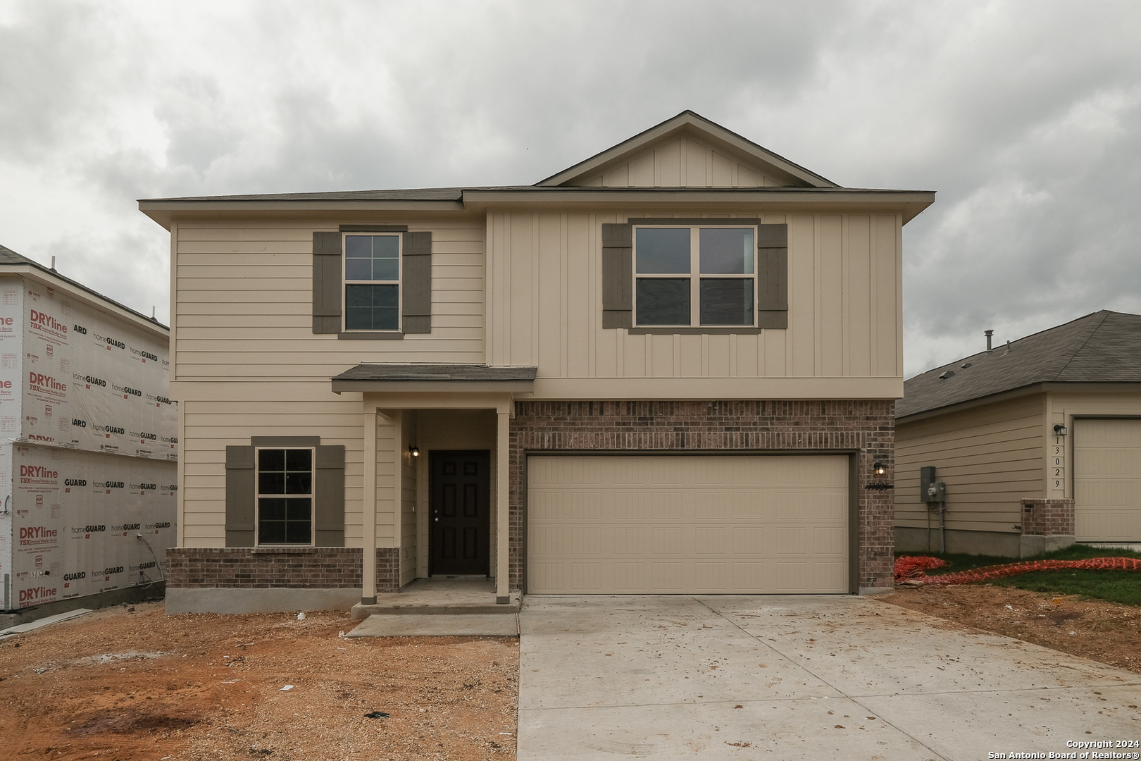 a front view of a house with a garage