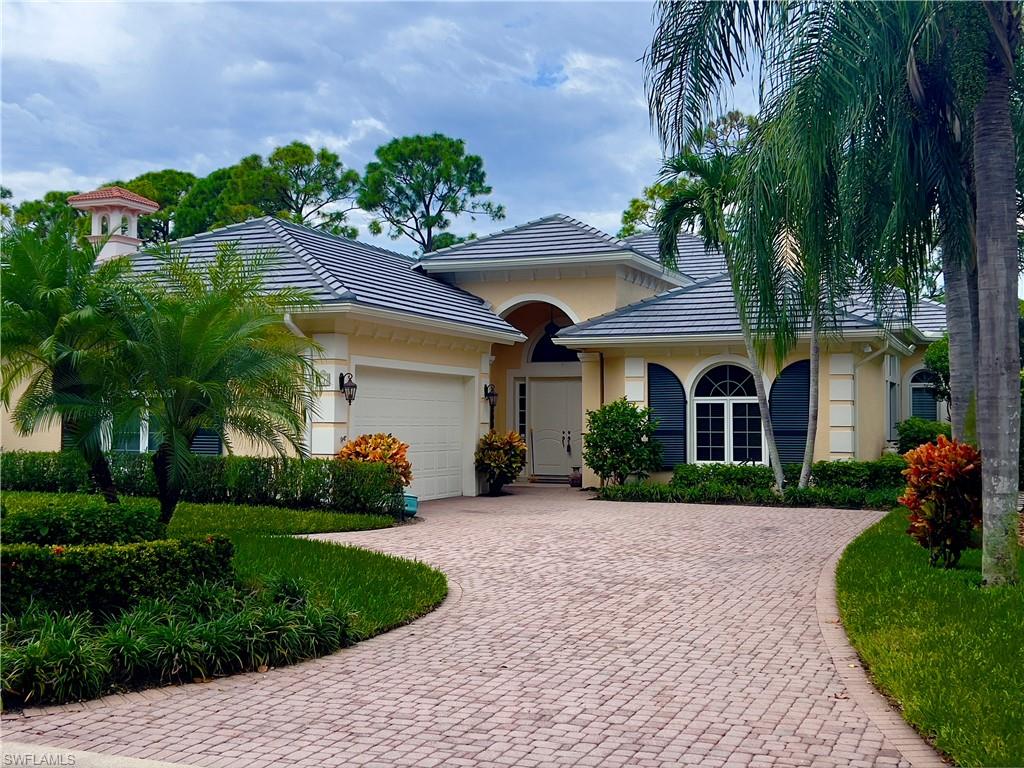 a front view of a house with a garden and plants