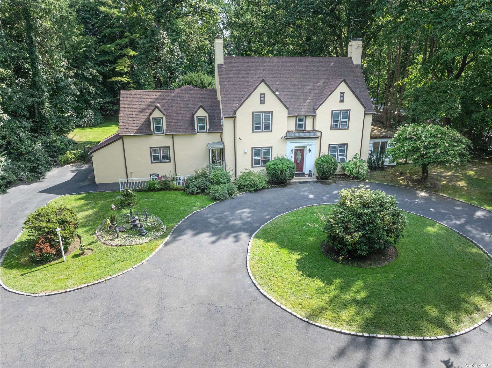 a view of a house with a yard patio and fire pit