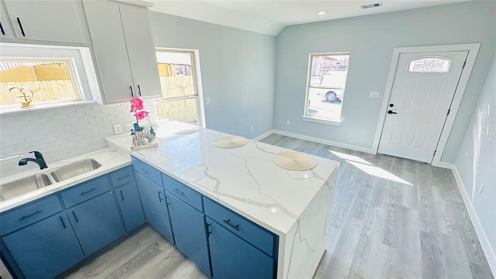 a en suite bathroom with a granite countertop sink and a window