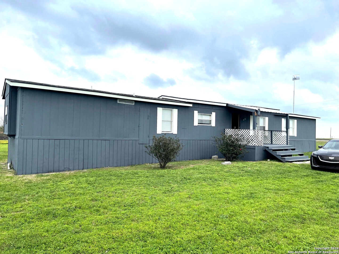 a view of a house with a yard and garage