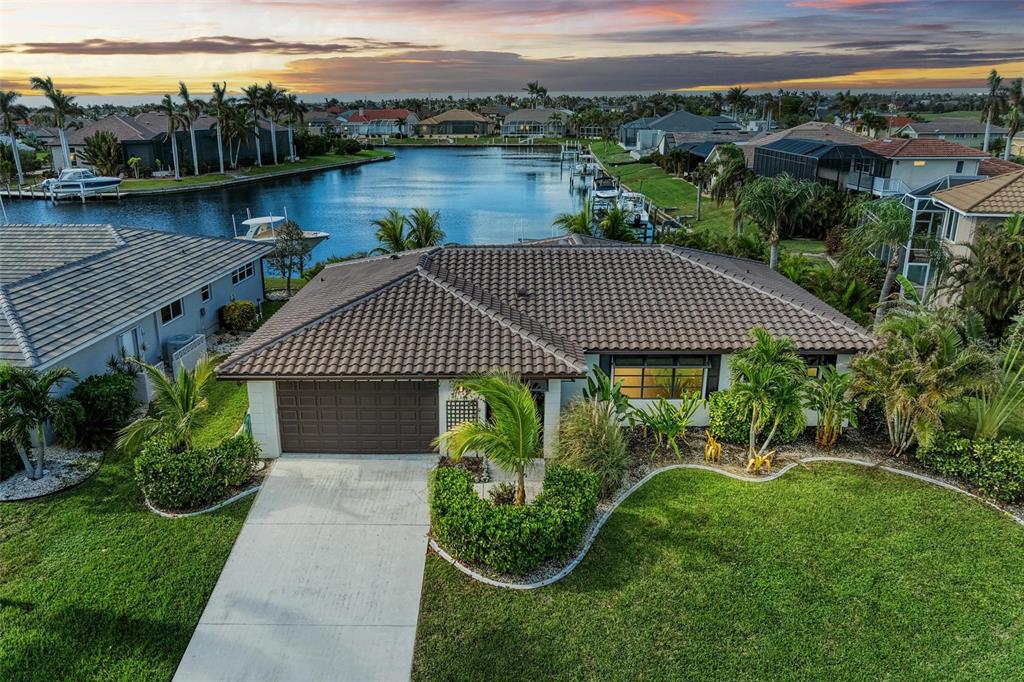 a view of a house with a yard and a pond