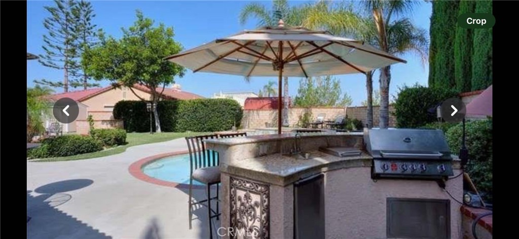 a patio with a table and chairs under an umbrella