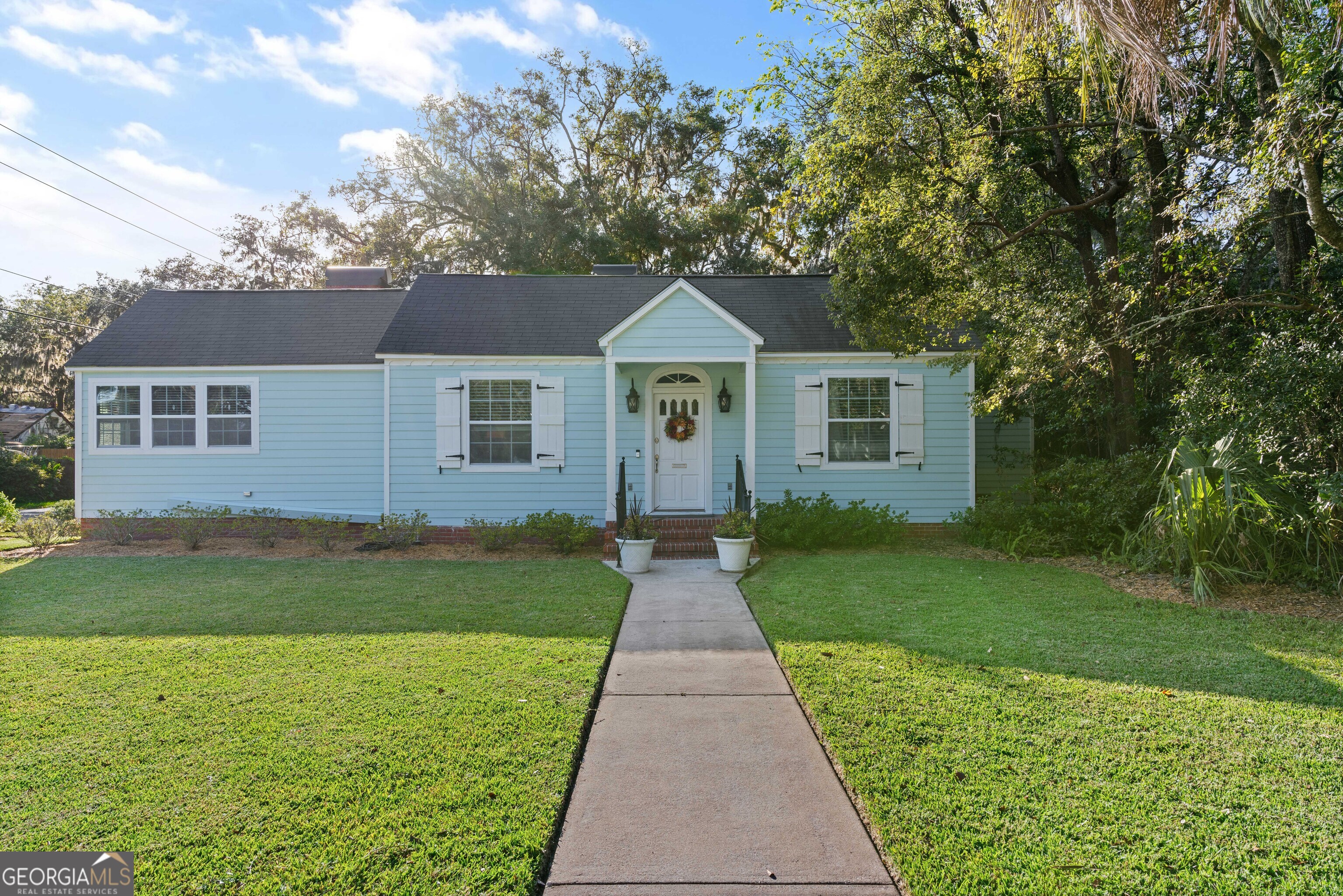 a front view of a house with garden