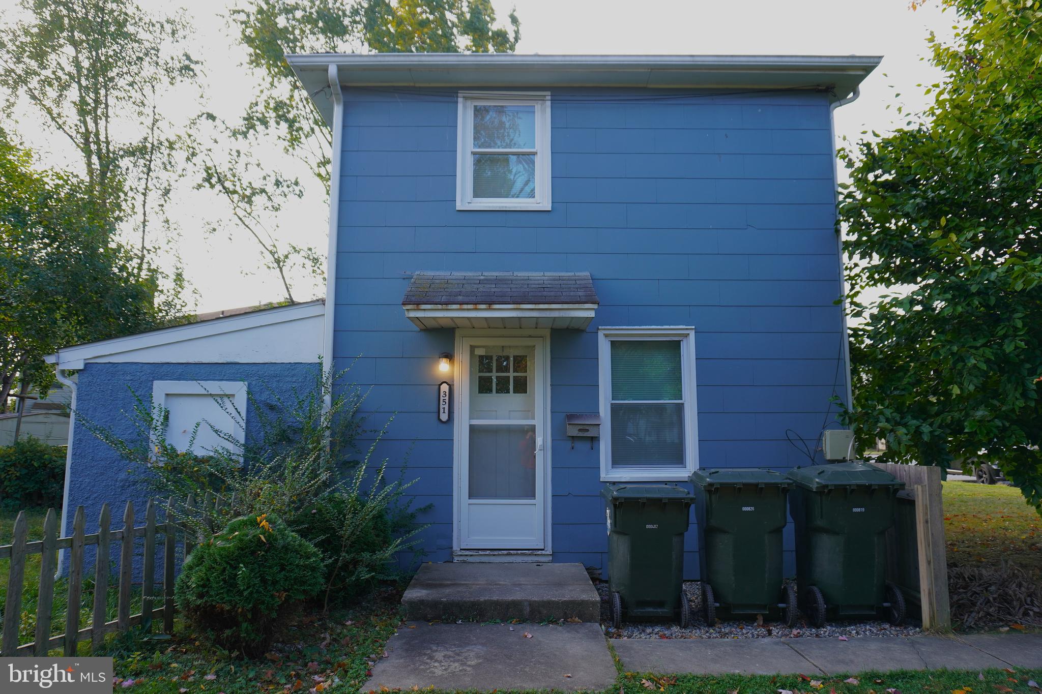 a front view of a house with plants