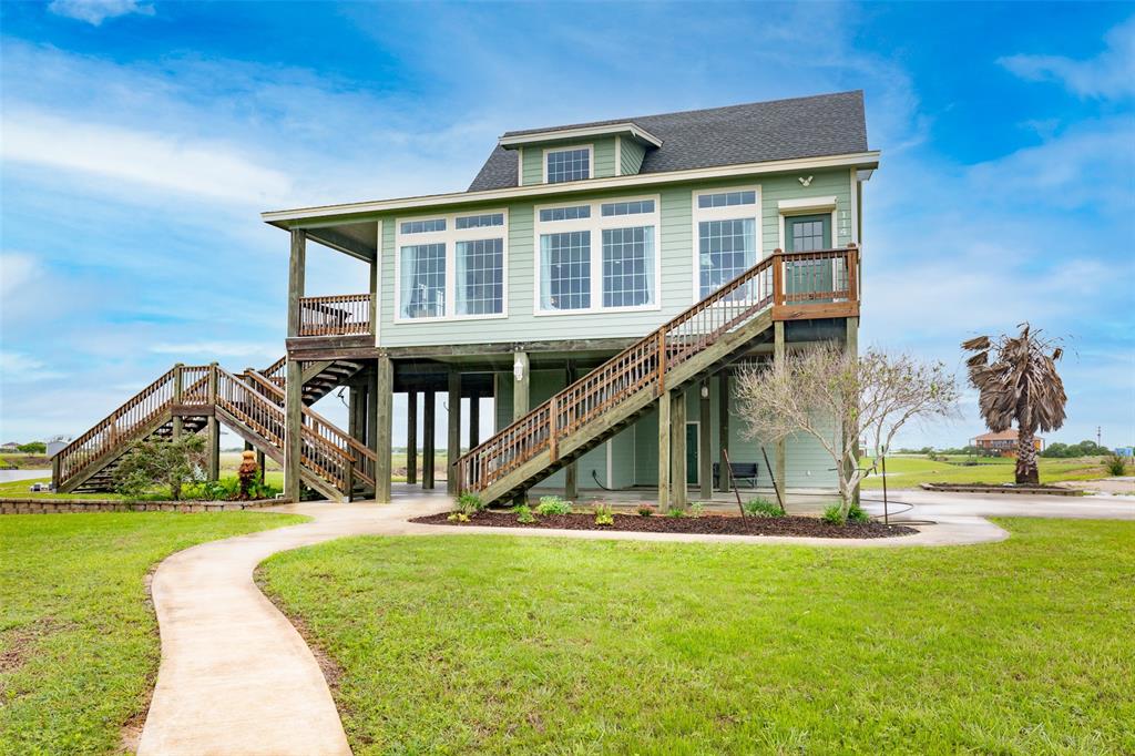 a view of house with swimming pool and green space