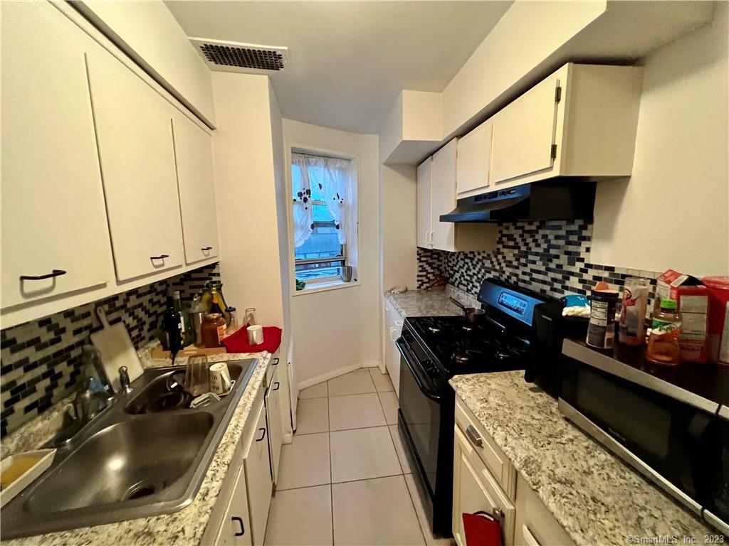 a kitchen with sink and cabinets