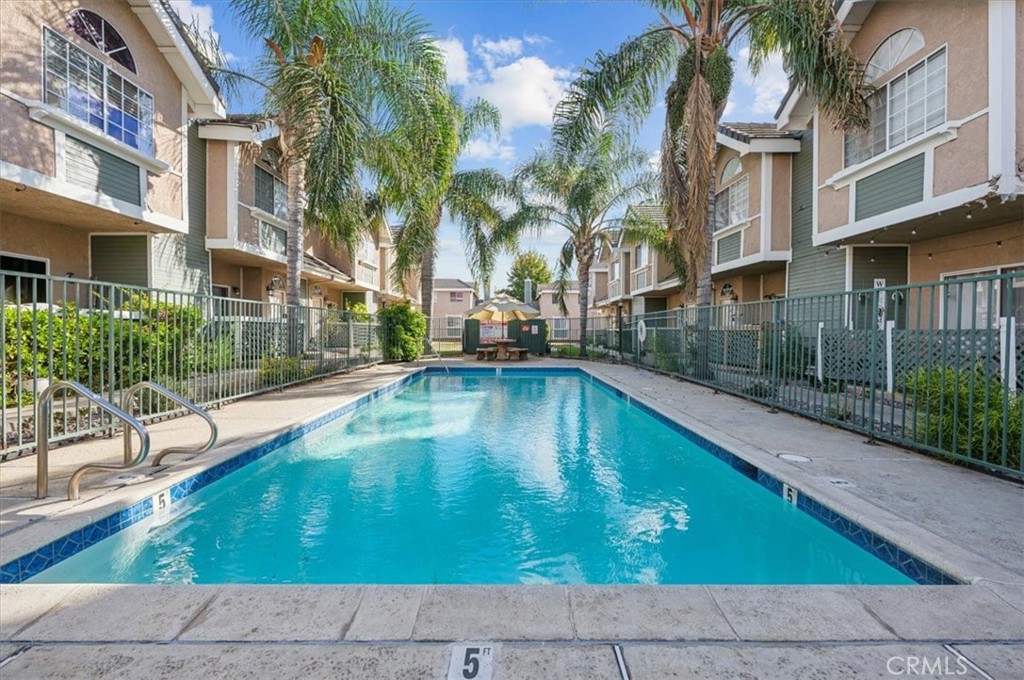 a swimming pool with outdoor seating and yard