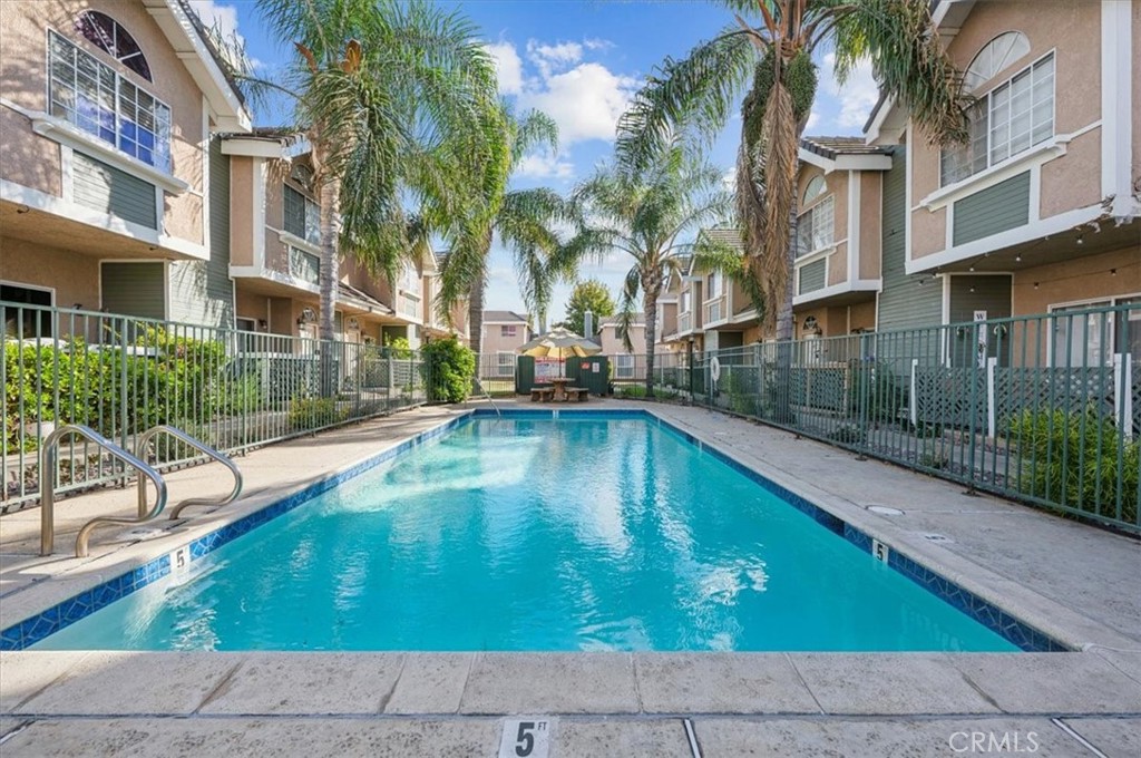 a swimming pool with outdoor seating and yard