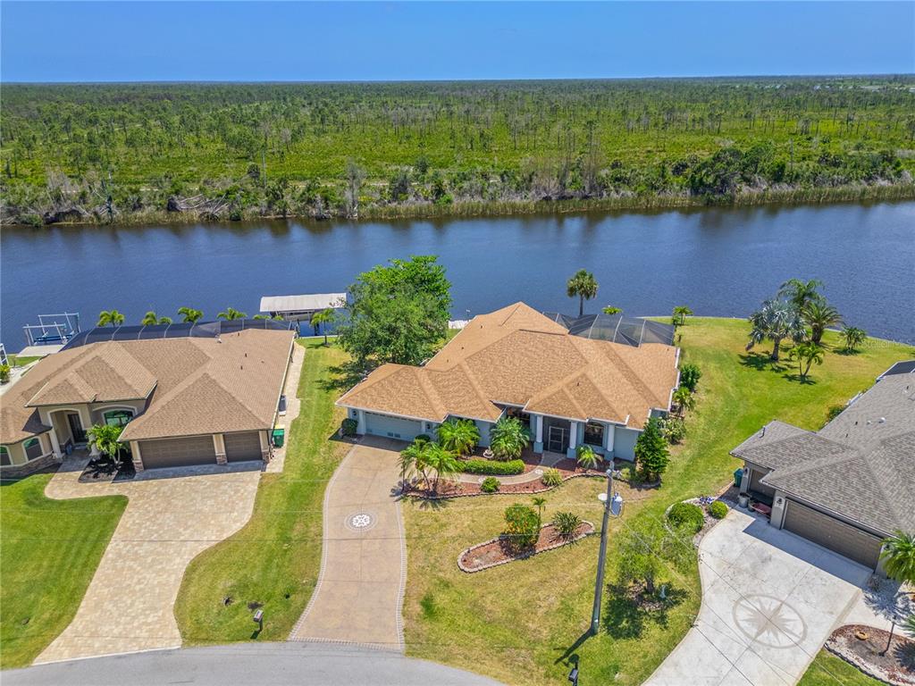 an aerial view of a house with outdoor space and lake view