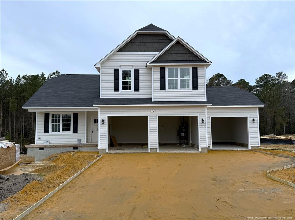 a front view of a house with yard and garage