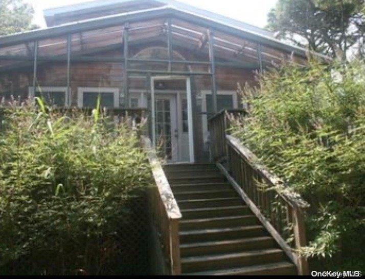 a view of a pathway of the house and front door