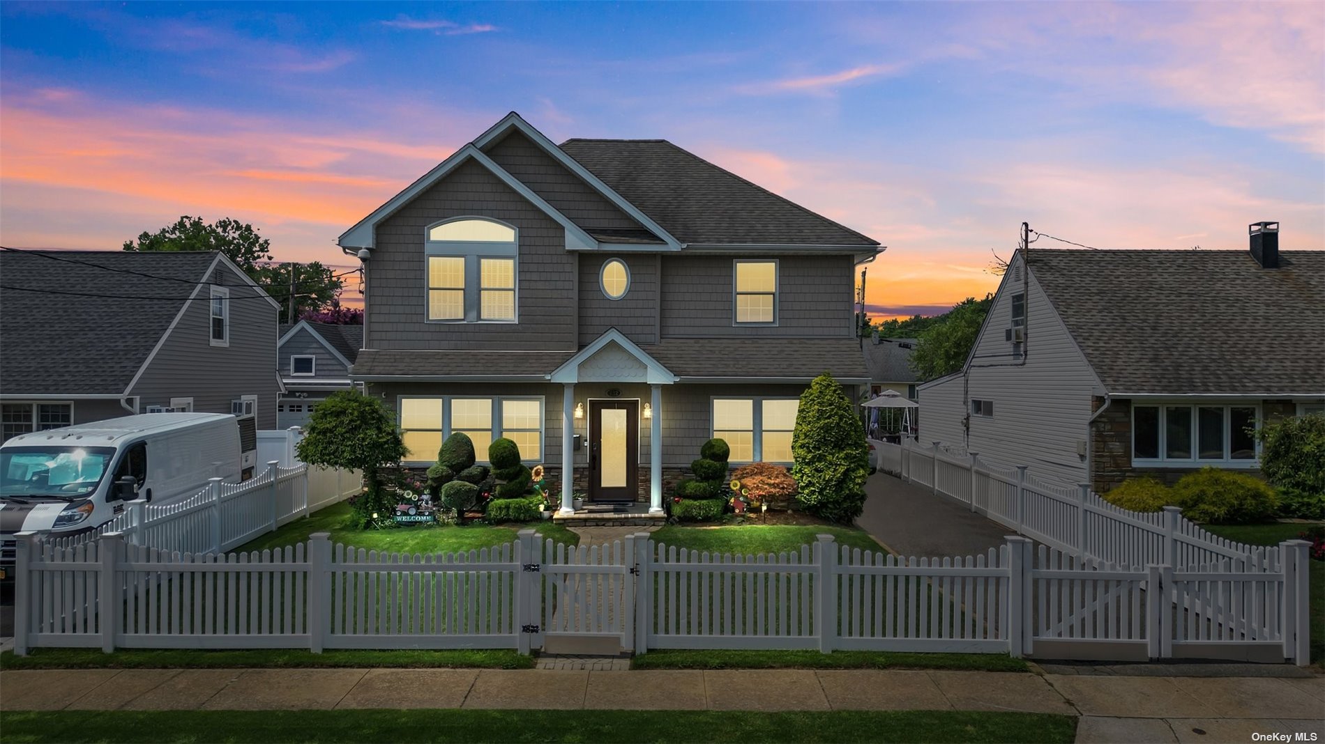 a front view of a house with a garden