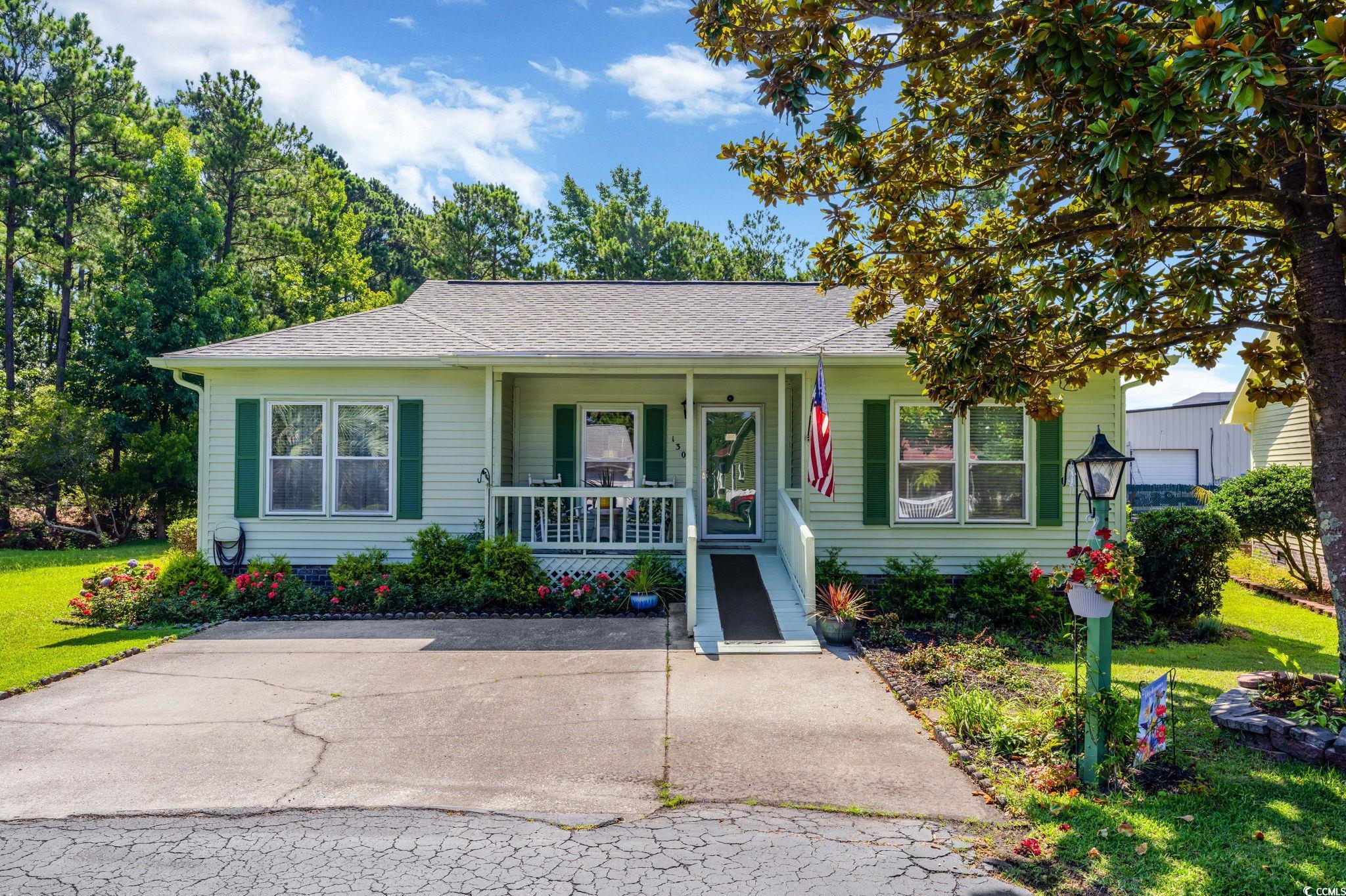 View of front of home with covered porch and a fro