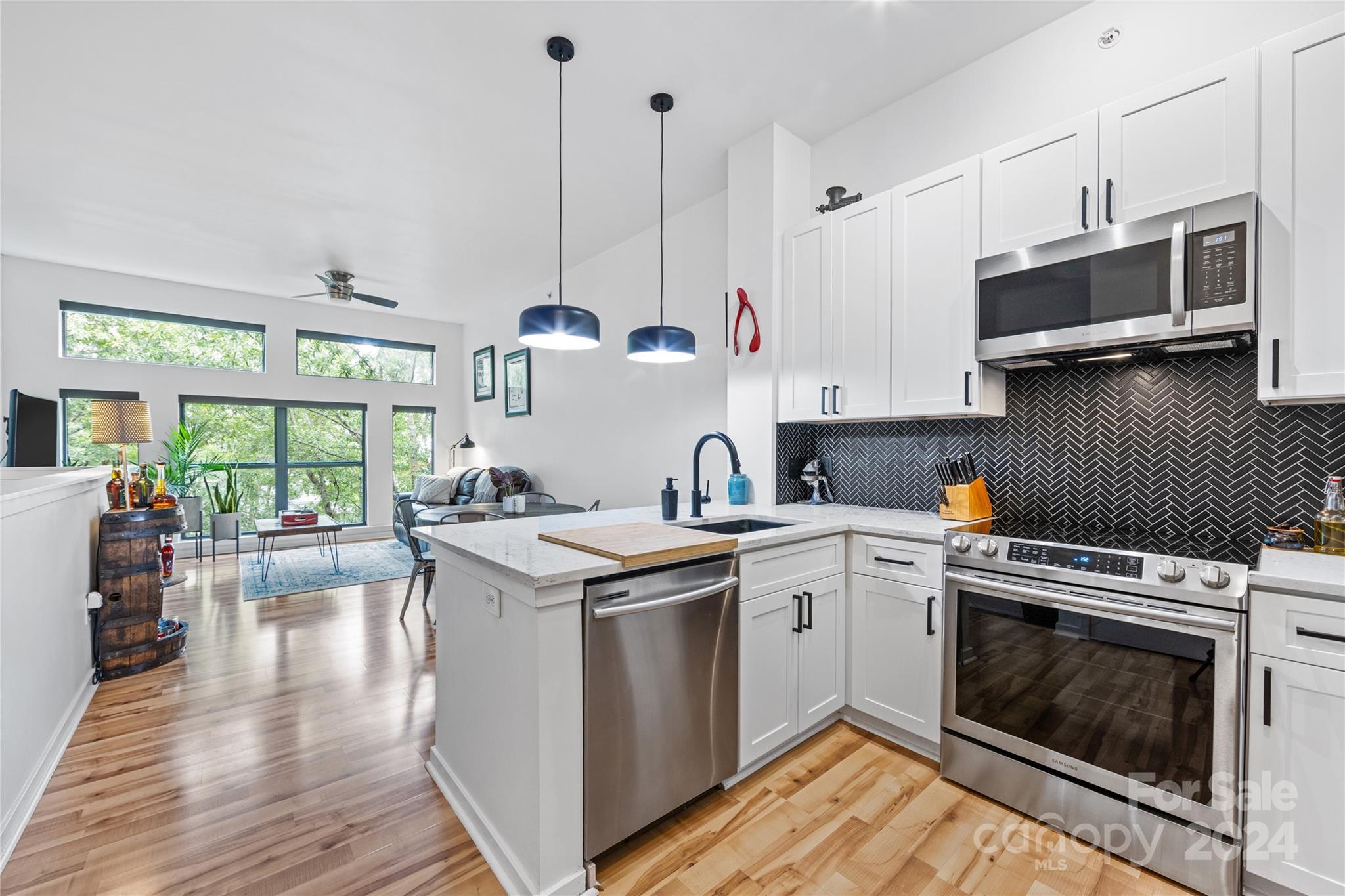 a kitchen with a stove a sink and a refrigerator