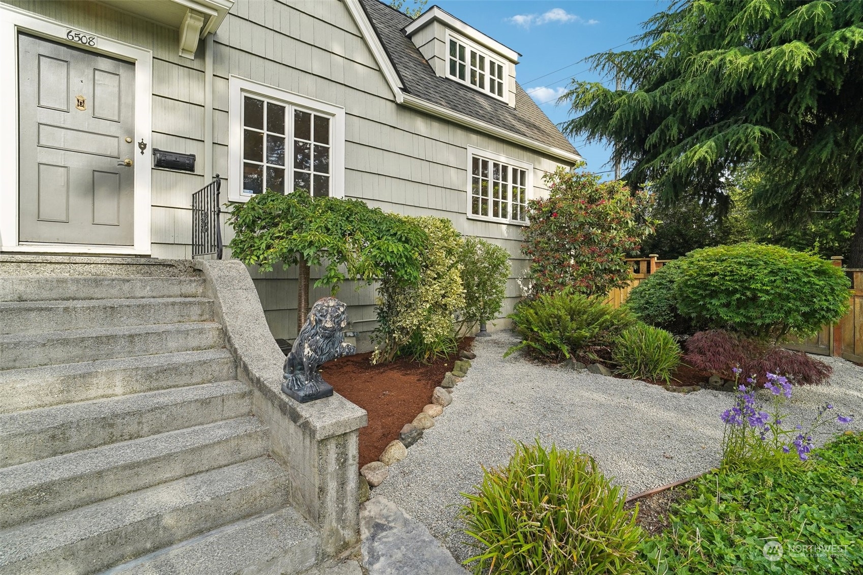 a view of a house with potted plants