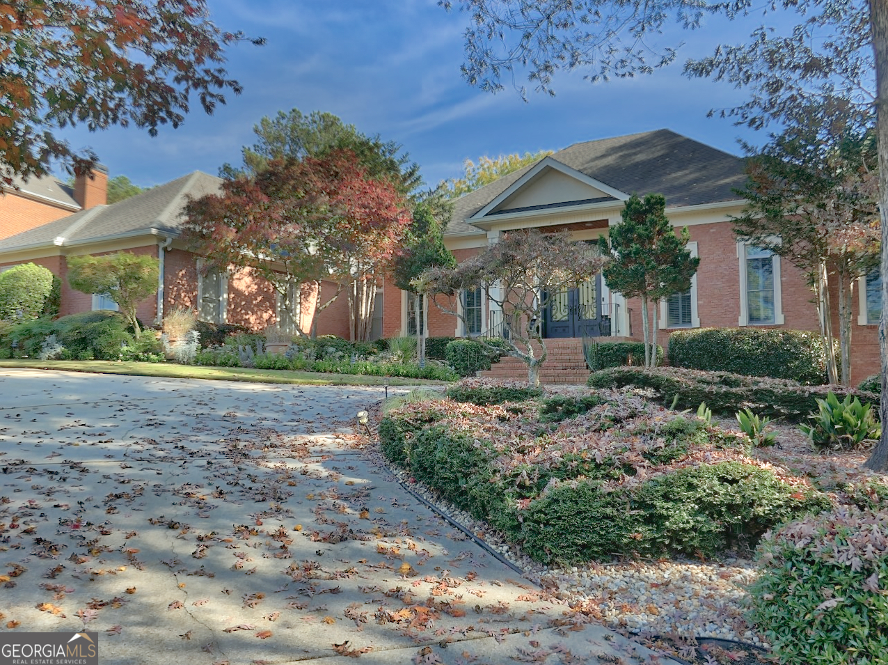 a front view of house with a garden