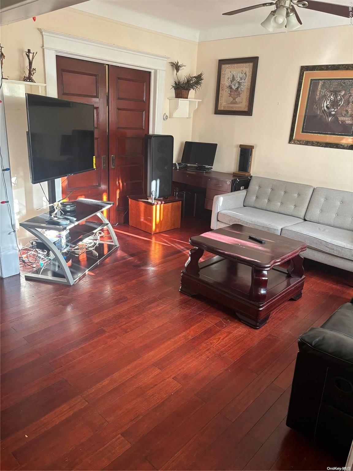 a living room with furniture and a flat screen tv