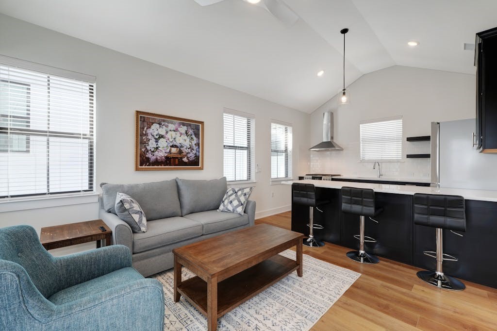 a living room with furniture and wooden floor