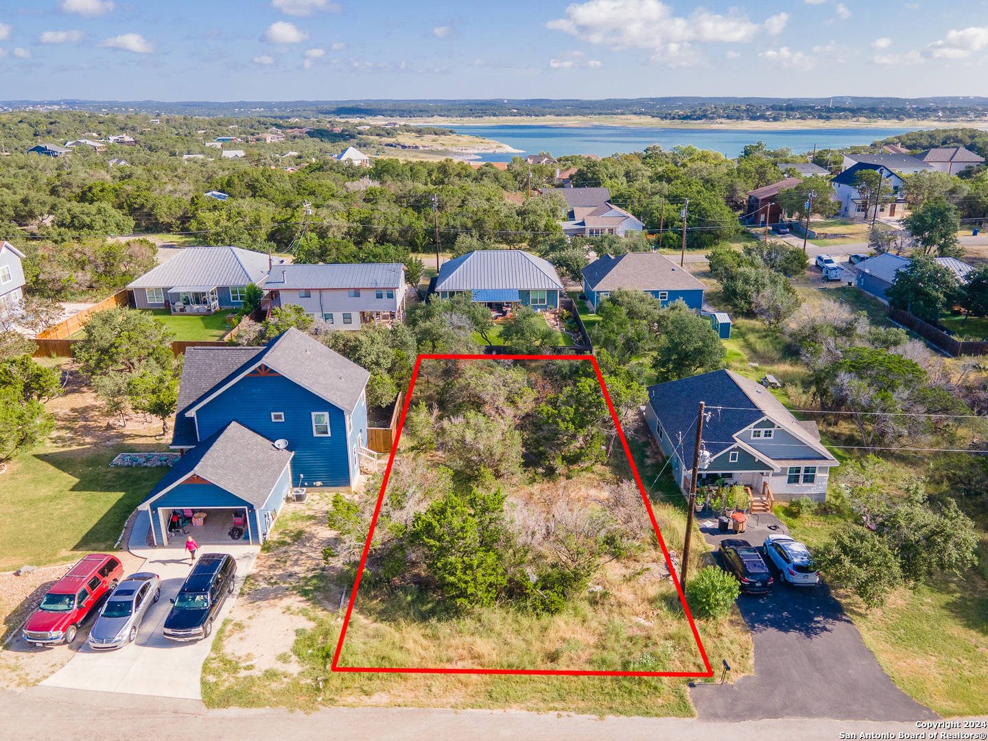 an aerial view of multiple houses with yard