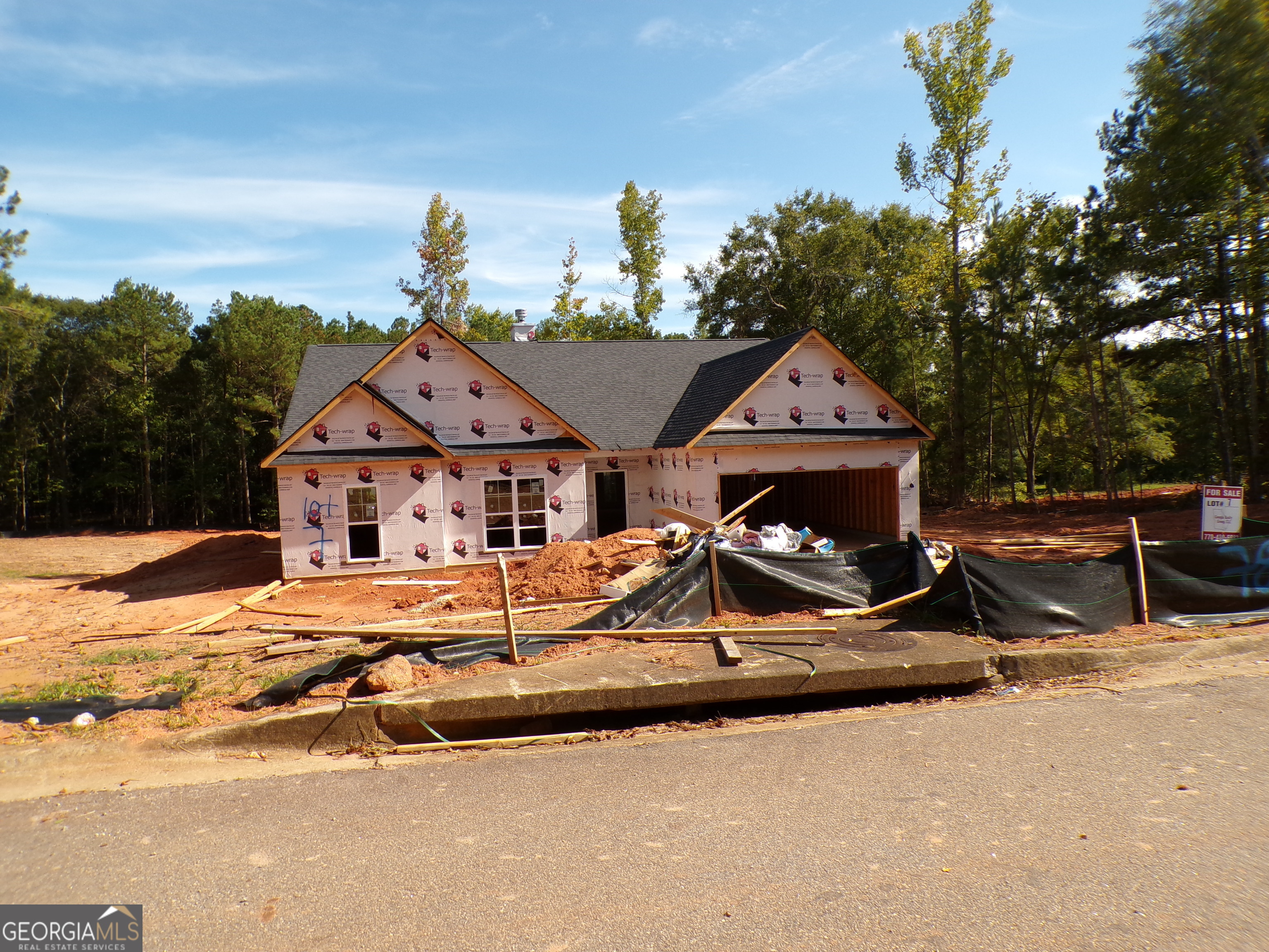 a view of a house with wooden fence