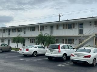 a view of a cars park in front of a building