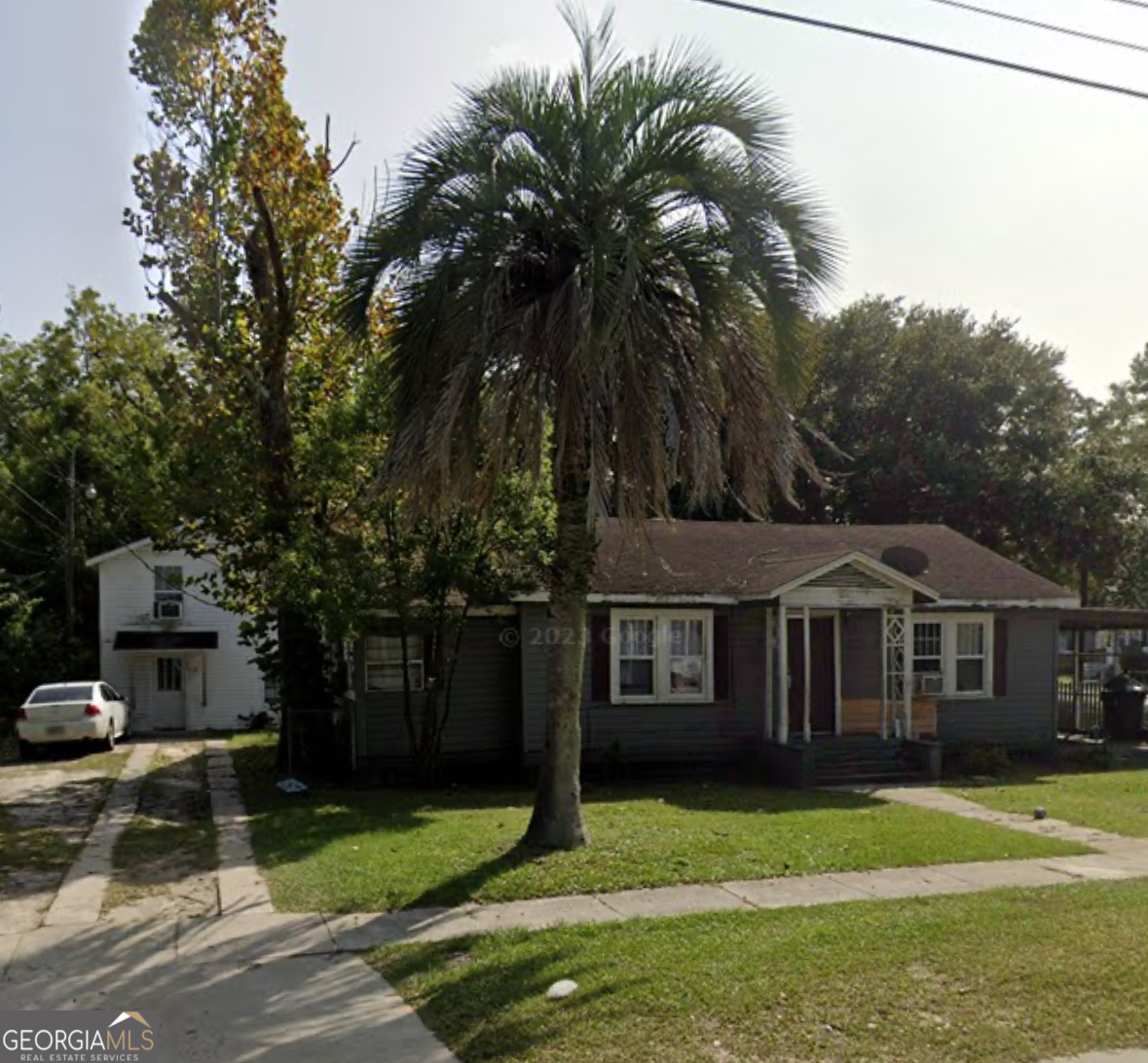 a front view of a house with a garden