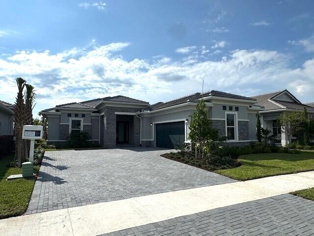 a front view of house with yard and trees around