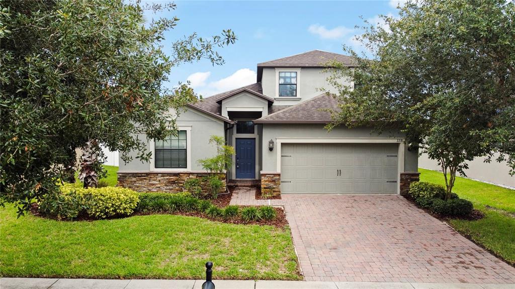 a front view of a house with a yard and garage