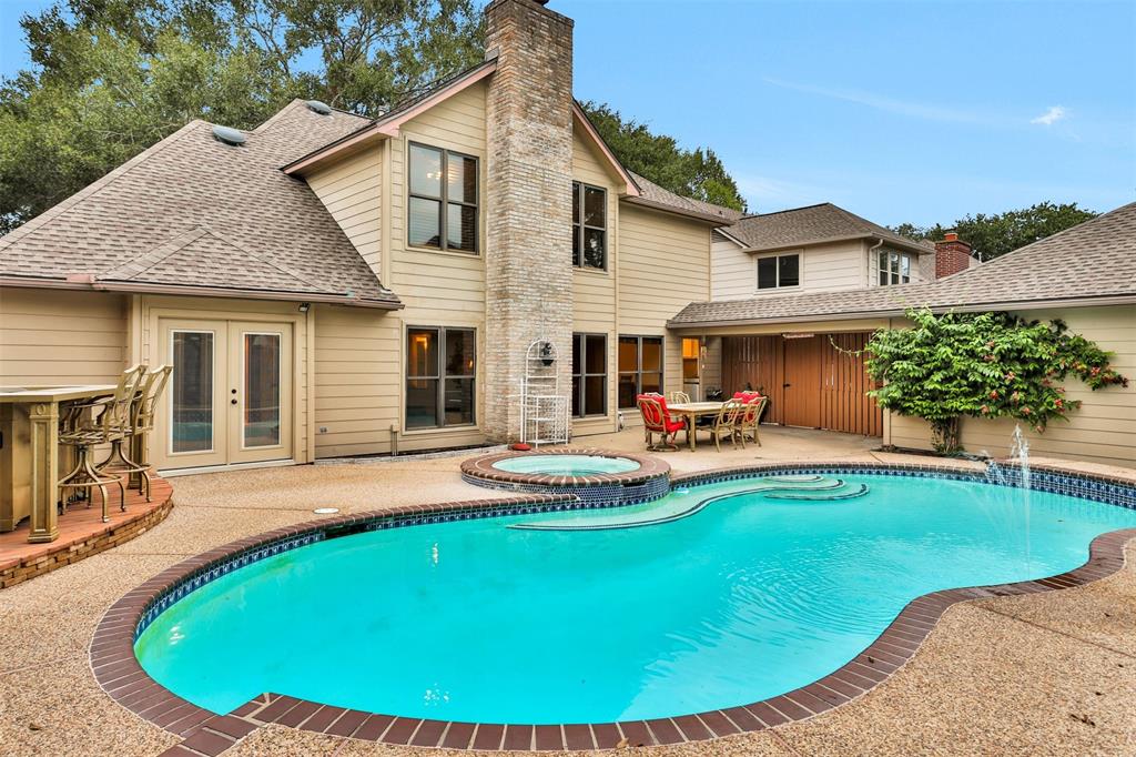 a view of a house with swimming pool and porch