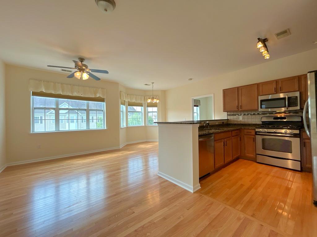 a kitchen with granite countertop a stove top oven and cabinets