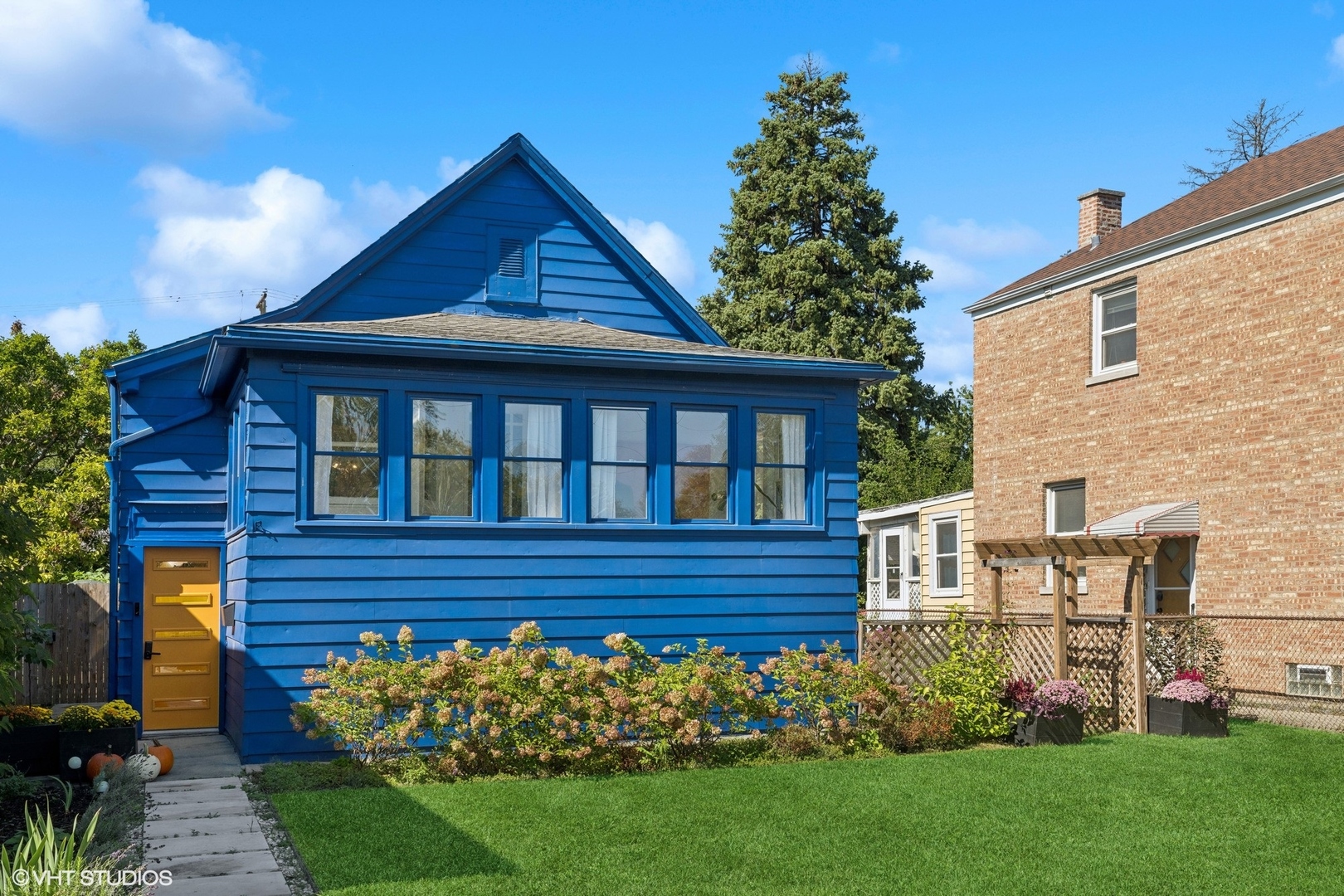 a front view of a house with a garden